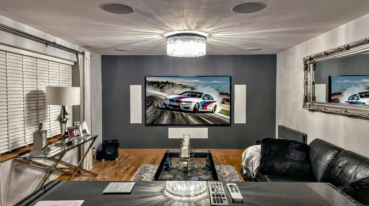 Home cinema installation with wall-mounted TV and in-wall speakers in Tiptree